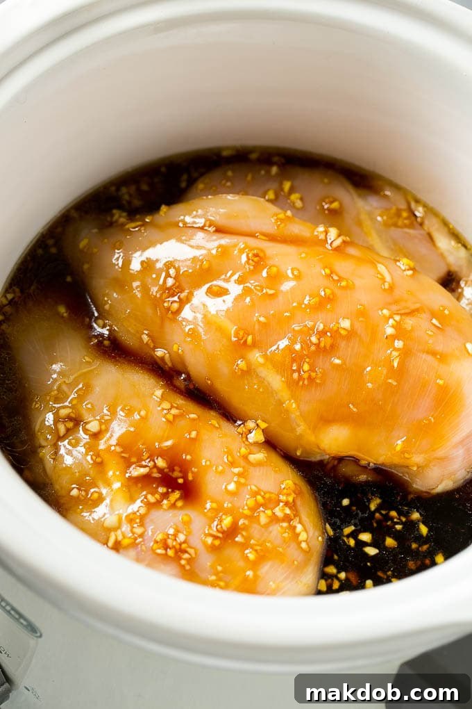 Slow Cooker Teriyaki Chicken Recipe | Crock Pot Teriyaki Chicken | Slow Cooker Chicken | Asian Chicken Chicken breasts in a crock pot with soy sauce, garlic and ginger.