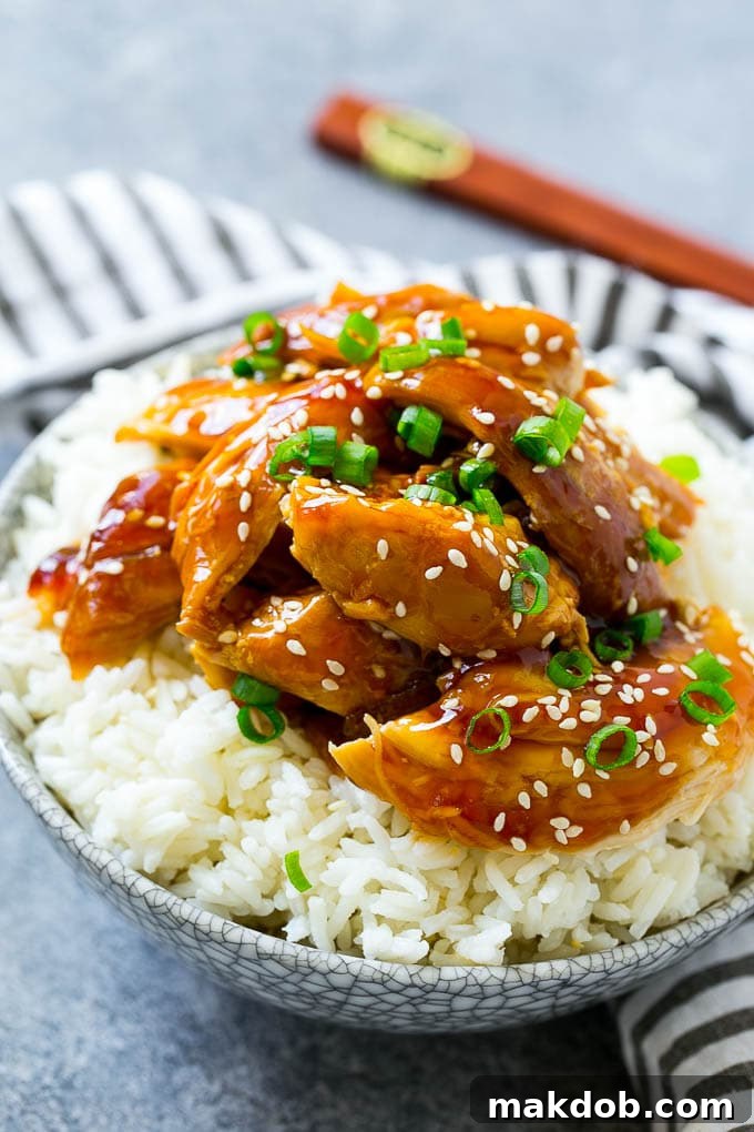 Effortless Slow Cooker Teriyaki Chicken 6 Shredded slow cooker teriyaki chicken served over rice.