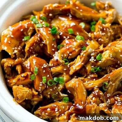 Effortless Slow Cooker Teriyaki Chicken 7 Slow cooker teriyaki chicken with shredded chicken breasts, homemade teriyaki sauce, sesame seeds and green onions.