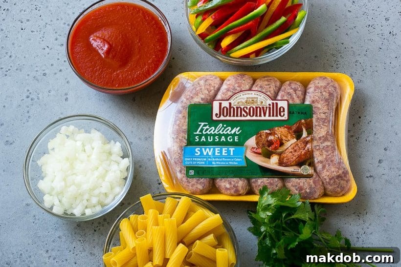 Sausage and Pepper Pasta Recipe | Italian Sausage Recipe | Sausage and Peppers | Easy Pasta #pasta #sausage #peppers #dinner #dinneratthezoo Ingredients like pork, tomato sauce onion and rigatoni.