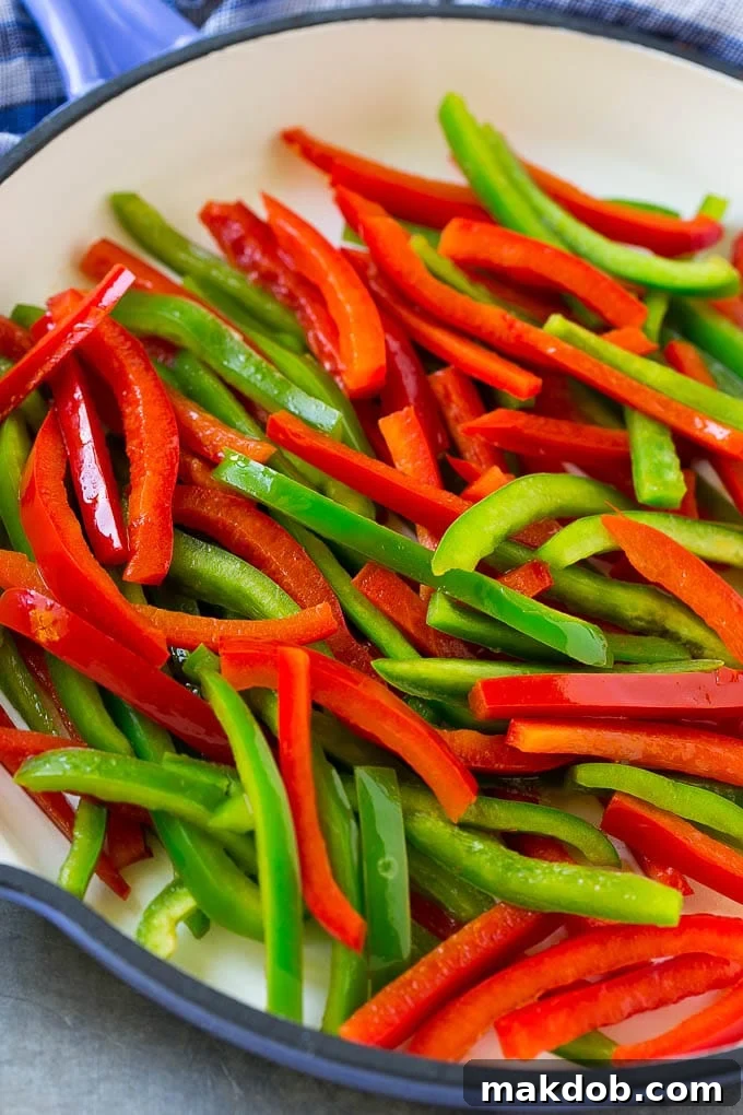 Pepper Steak Stir Fry Recipe | Chinese Pepper Steak | Steak Stir Fry | Beef Stir Fry #steak #peppers #stirfry #chinesefood #dinneratthezoo #beef Cooked red and green bell peppers in a skillet.