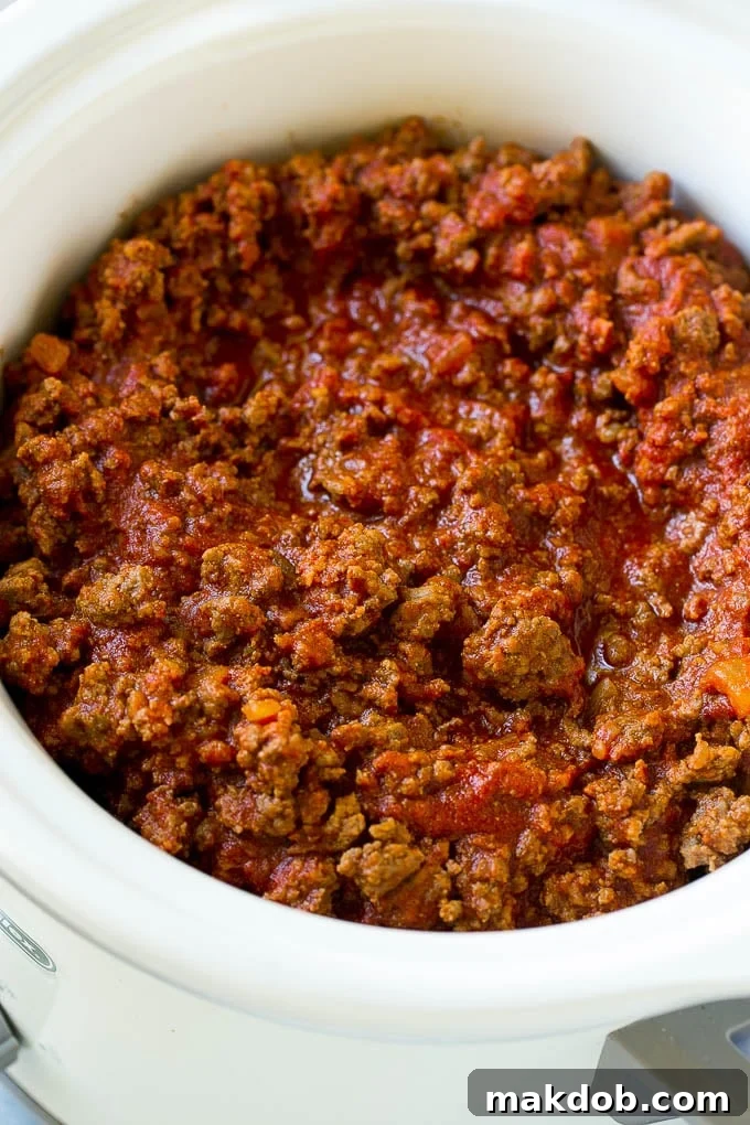Slow Cooker Sloppy Joes Recipe | Crock Pot Sloppy Joes | Homemade Sloppy Joes #beef #slowcooker #crockpot #sandwich #dinneratthezoo A slow cooker full of sloppy joe meat.