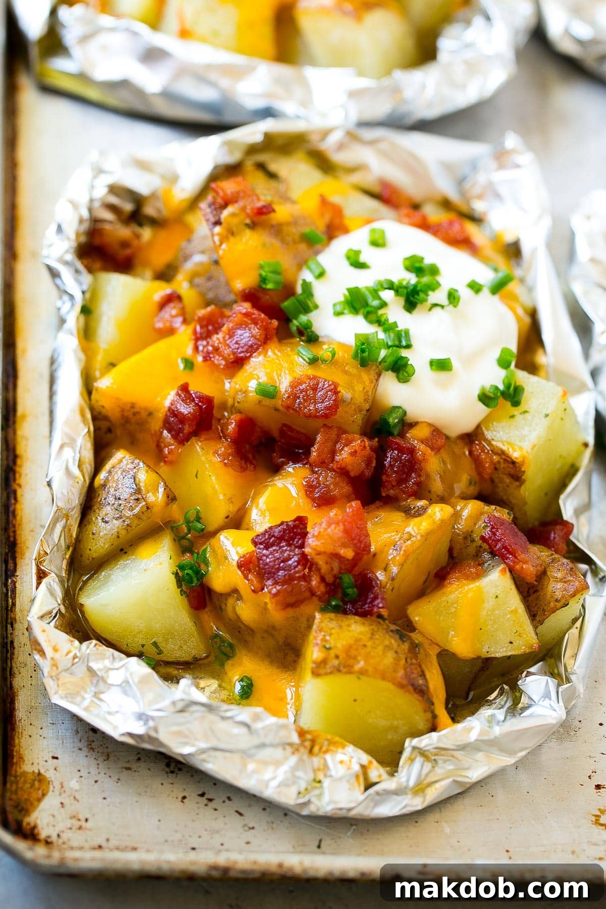 Grill-Wrapped Potatoes 6 Grilled potatoes in foil with cheese, bacon and sour cream.