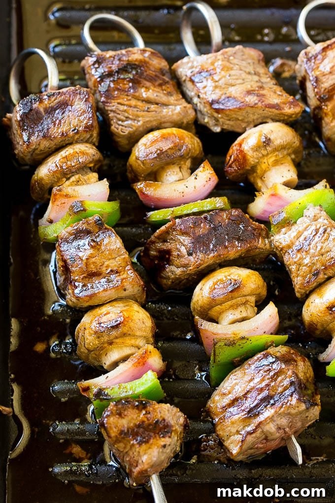 Steak kabobs on a grill pan.