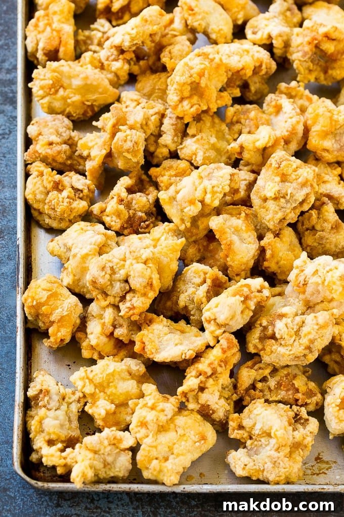 Crispy fried chicken on a sheet pan.