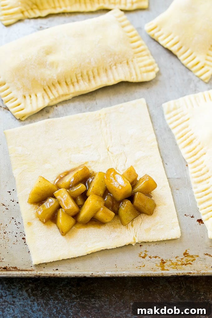 Fried Apple Pies Recipe | McDonald's Copycat Recipe | Apple Pie | Apple Hand Pies #pie #apples #applepie #dessert #snack #dinneratthezoo A sheet of puff pastry topped with homemade apple pie filling.