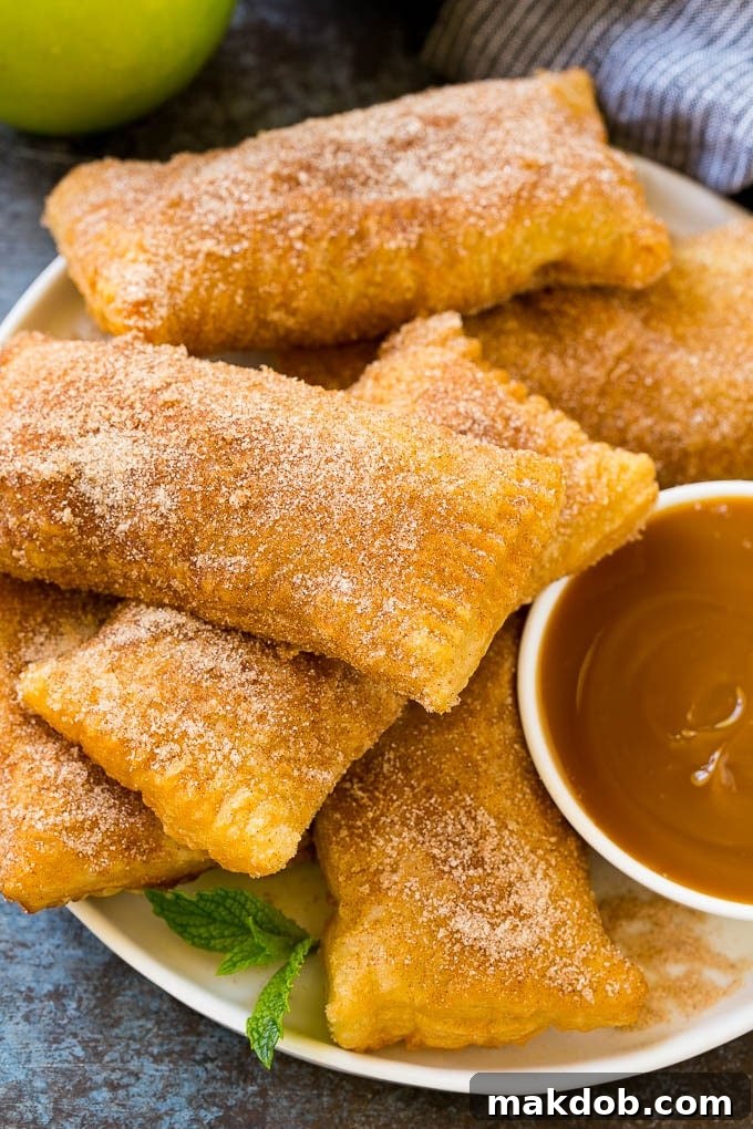 Fried Apple Pies Recipe | McDonald's Copycat Recipe | Apple Pie | Apple Hand Pies #pie #apples #applepie #dessert #snack #dinneratthezoo A plate of deep fried apple pies dusted with cinnamon sugar.