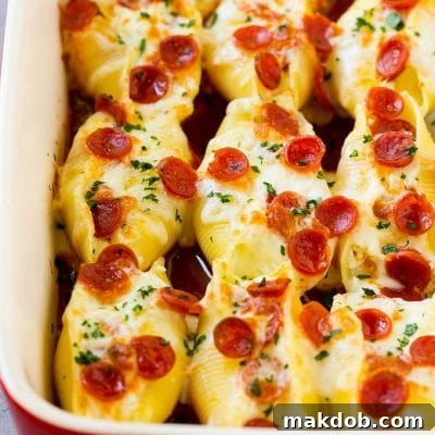Inside-Out Pizza Shells 2 A baking dish full of pizza stuffed shells, topped with melted cheese and pepperoni.