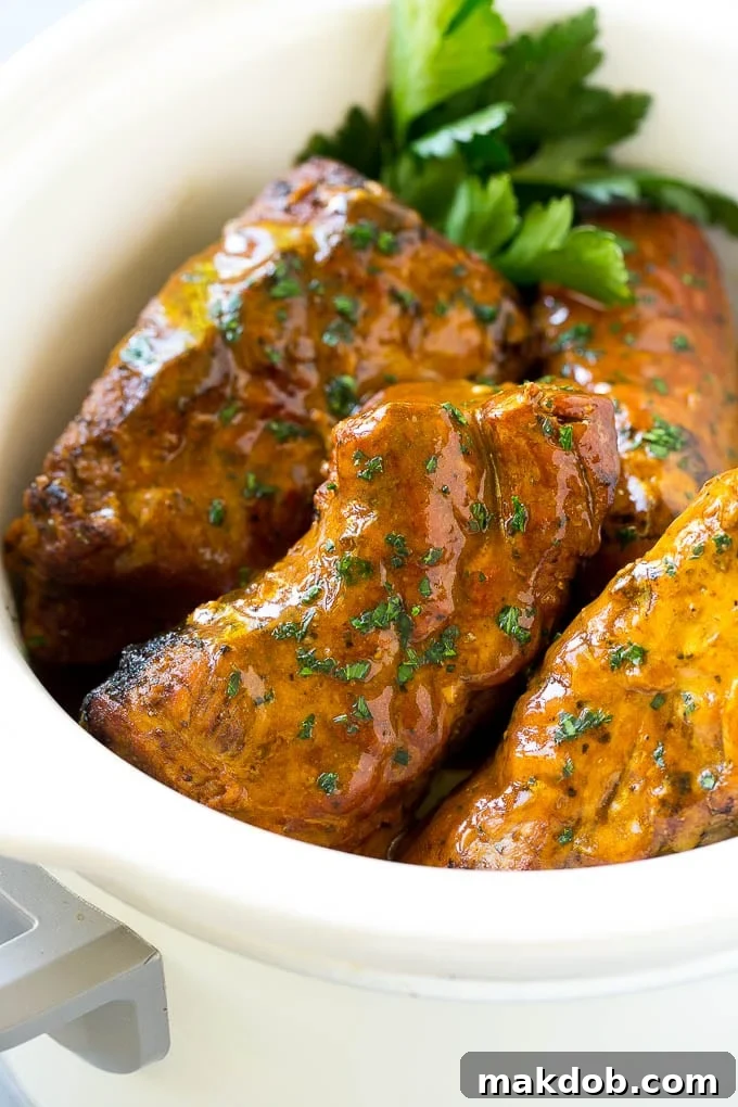 Slow Cooker Pork Tenderloin Recipe | Crock Pot Pork Tenderloin | Easy Pork Tenderloin #slowcooker #crockpot #pork #dinner #dinneratthezoo Slow cooker pork tenderloins coated with sauce, inside a crock pot.