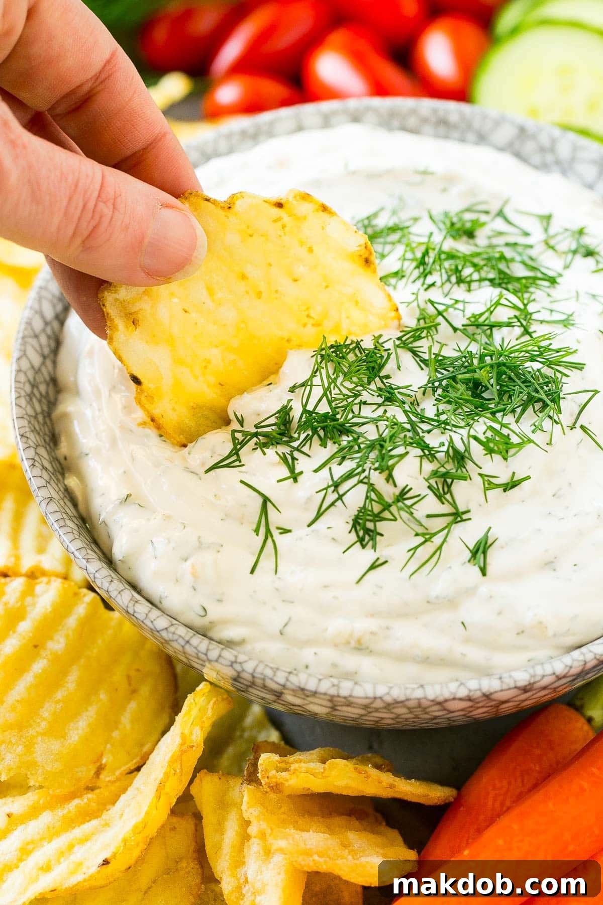 Creamy Dill Delight 5 A potato chip scooping up a serving of creamy herb dip.