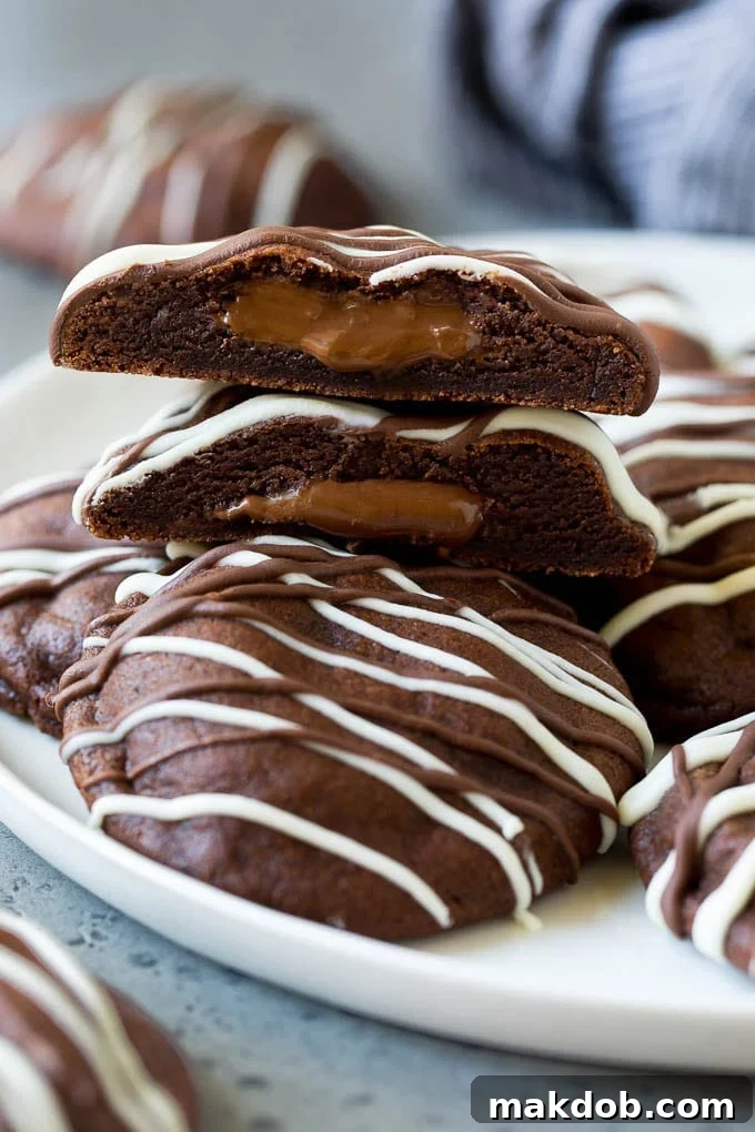 Nutella Stuffed Chocolate Cookies Recipe A serving plate of Nutella stuffed chocolate cookies, with one cookie cut in half revealing its gooey Nutella center.