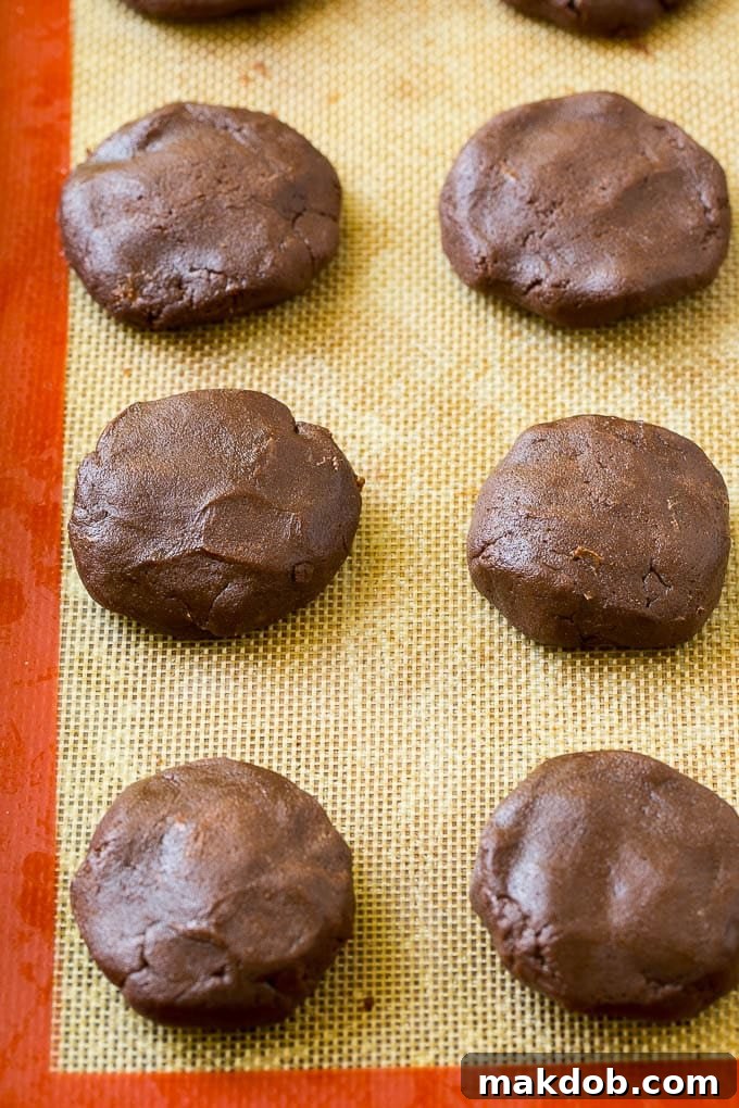 Nutella Cookie Dough Ready to Bake Nutella stuffed cookie dough arranged neatly on a baking sheet, ready for the oven.