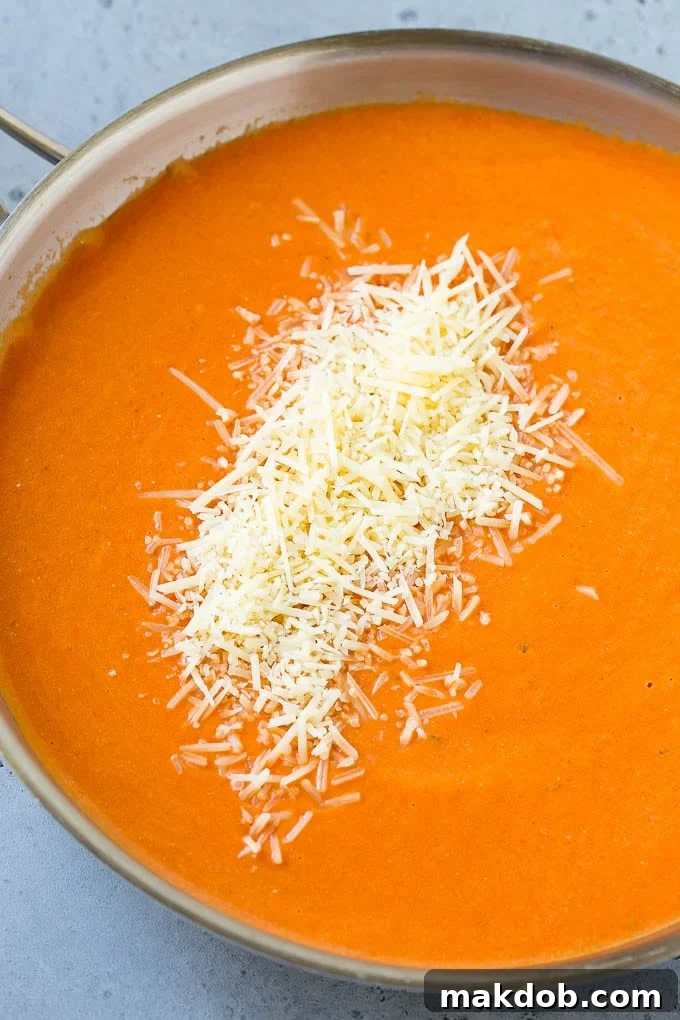 A close-up of the rich, creamy tomato sauce, beautifully infused with Parmesan cheese, before being tossed with pasta.