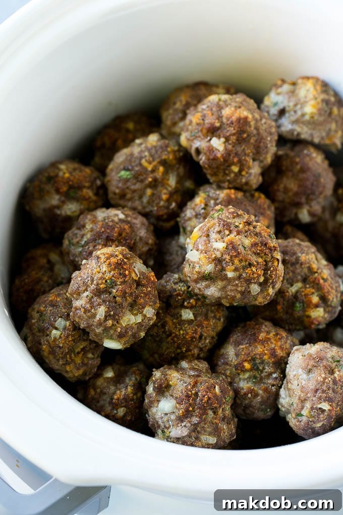 Classic Italian Slow Cooker Meatballs 5 Broiled meatballs in a slow cooker.