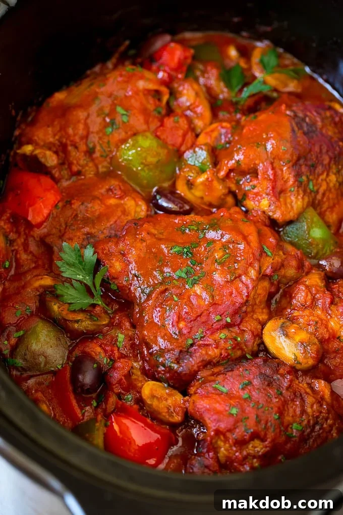 Slow Cooker Chicken Cacciatore Recipe | Italian Chicken #chicken #crockpot #slowcooker #dinner #italianfood #peppers #dinneratthezoo Slow cooker chicken cacciatore with mushrooms, peppers and olives.