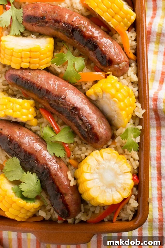 Close-up of a serving of One Pot Sausage and Rice Casserole, highlighting the tender rice, sliced sausage, and colorful vegetables.