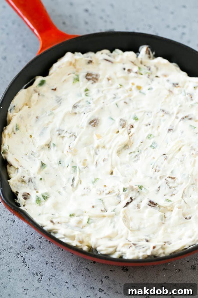 Philly Cheesesteak Dip Recipe | Cheesy Dip | Baked Cheese Dip #steak #dip #appetizer #cheese #dinneratthezoo Steak, peppers and onions in a skillet, mixed with cream cheese.