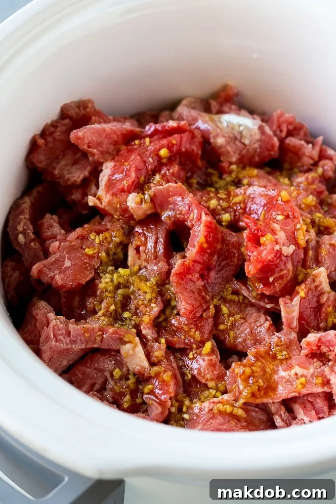 Flank steak strips generously coated in a rich, glossy soy, ginger, and garlic sauce.