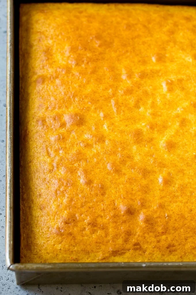 A baked yellow cake, perfectly golden and ready for crumbling.