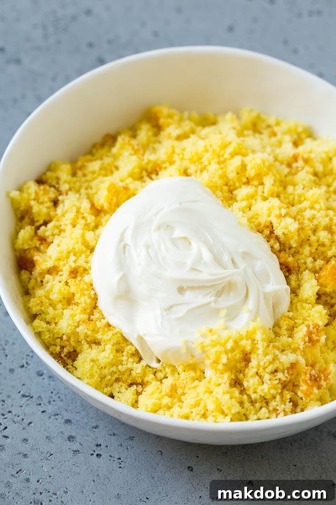 Cake crumbs with frosting in a bowl, ready to be mixed into a pliable dough.