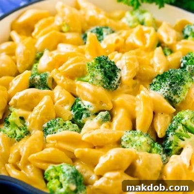 A skillet of broccoli mac and cheese in a creamy cheddar sauce.