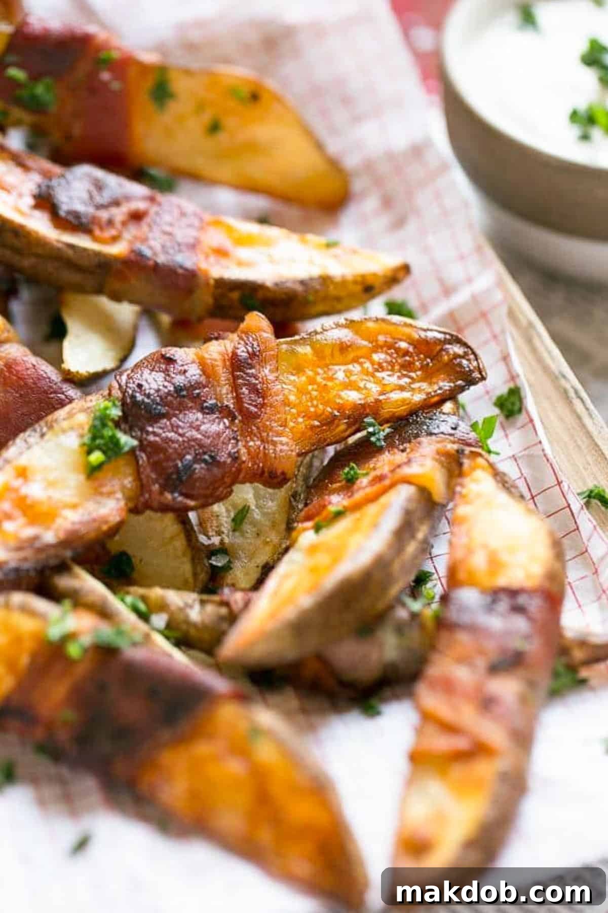 French fries wrapped in bacon and topped with parsley.