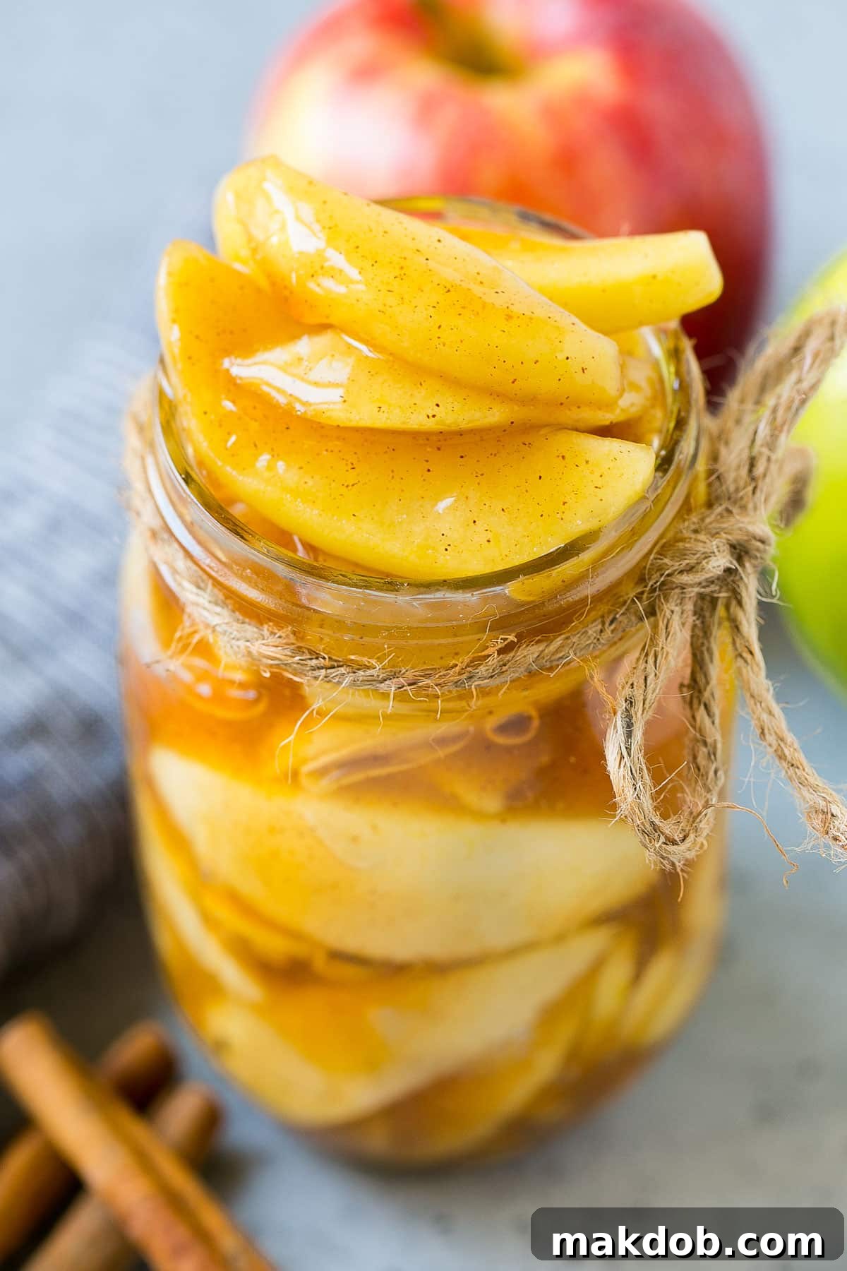 A glass jar filled with luscious homemade apple pie filling, ready for storage or immediate use.