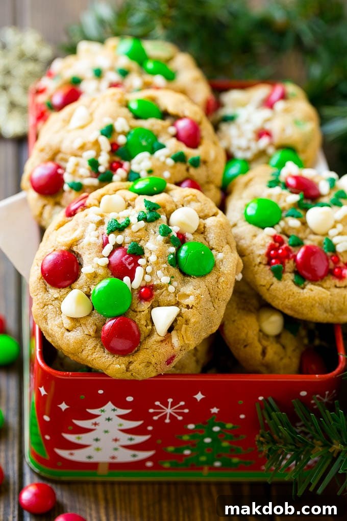 Christmas Monster Cookies Recipe | Oatmeal Cookies | Peanut Butter Cookies | M&M's Cookies #baking #cookies #dessert #peanutbutter #chocolate #dinneratthezoo #christmas #sprinkles Christmas monster cookies in a gift tin.