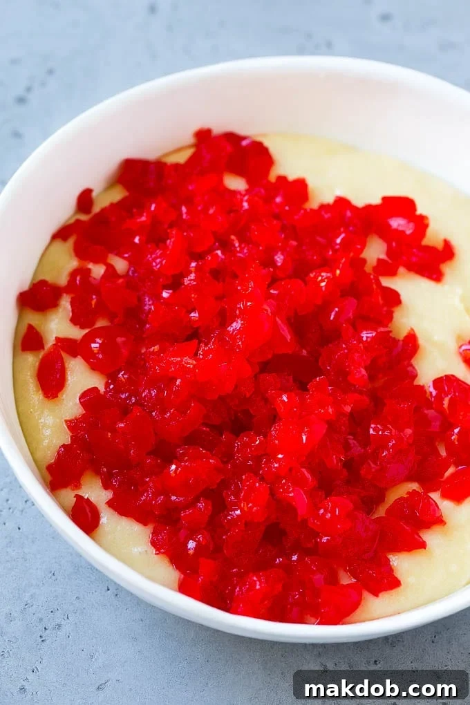 Cherry Muffins Recipe | Maraschino Cherry Muffins #cherries #cherry #muffins #baking #dessert #sweets #dinneratthezoo Muffin batter topped with chopped maraschino cherries, ready to be mixed.