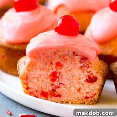 Ruby Red Cherry Muffins 2 Cherry muffins studded with maraschino cherries and topped with pink glaze.