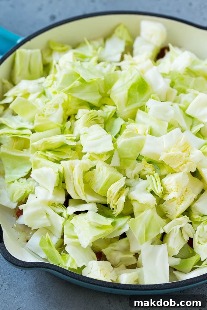 Bacon, onions and cabbage in a skillet.