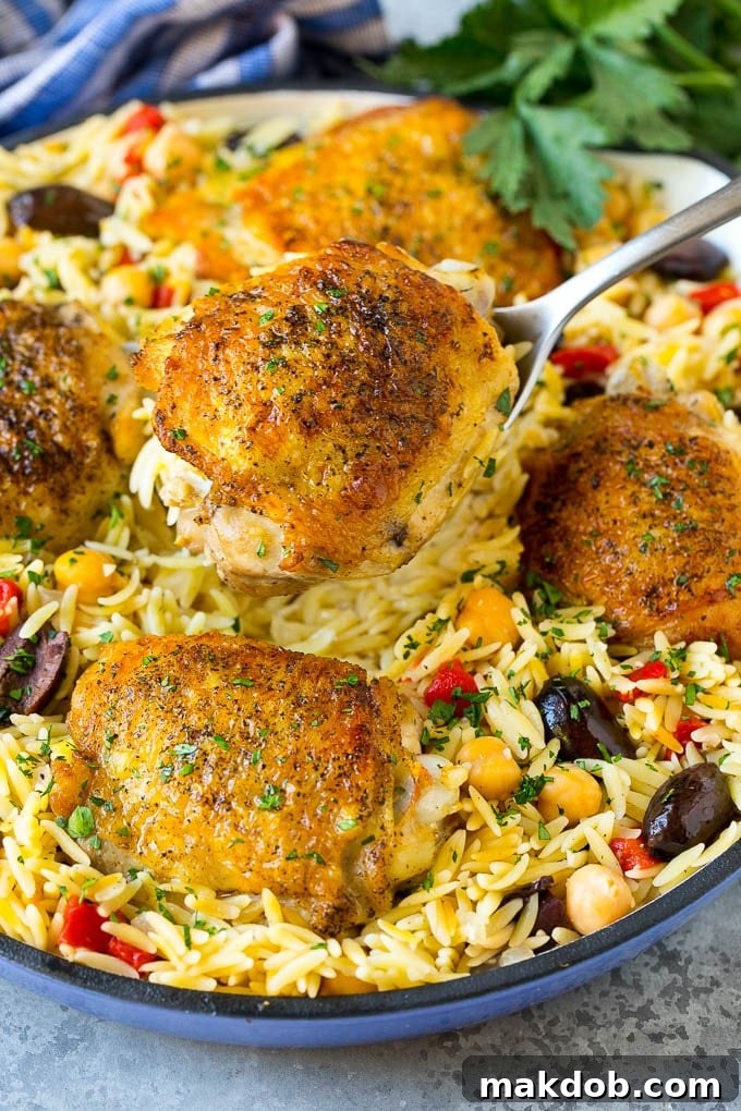 A spoon serving up a portion of Mediterranean chicken thighs.
