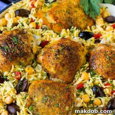 A pan of Mediterranean chicken with orzo, chickpeas and vegetables.