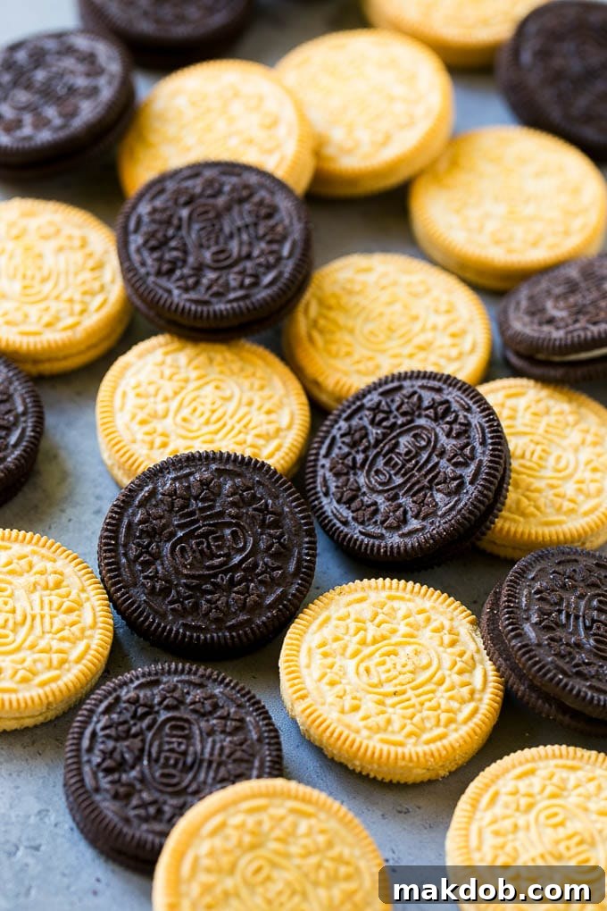 Chocolate and vanilla Oreo cookies laid out on a surface.