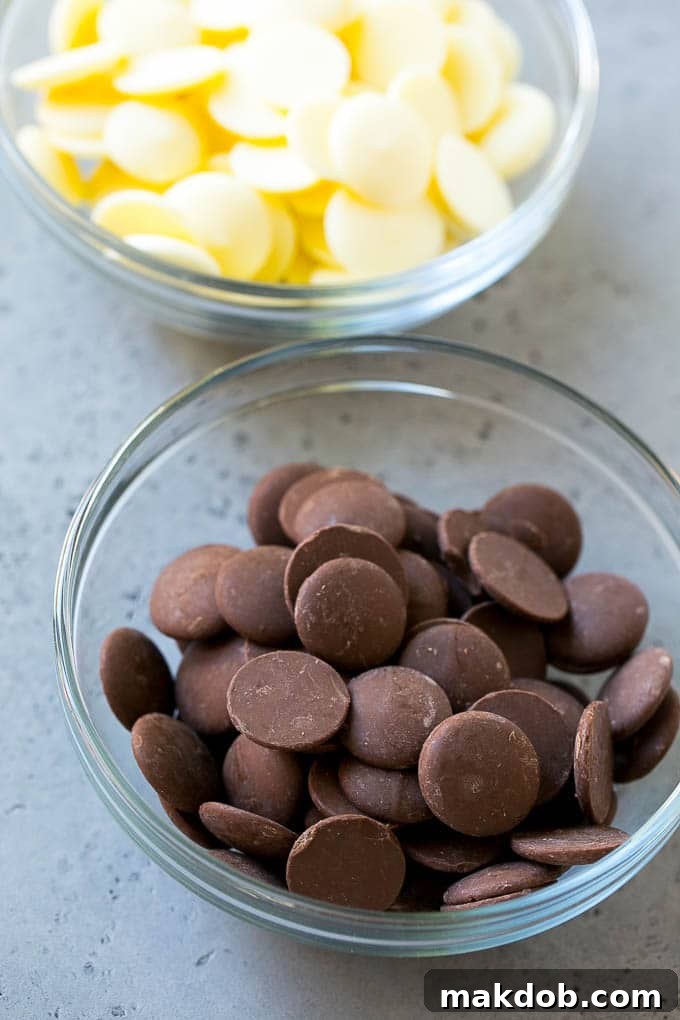 Bowls of dark chocolate candy melts and white chocolate candy melts.