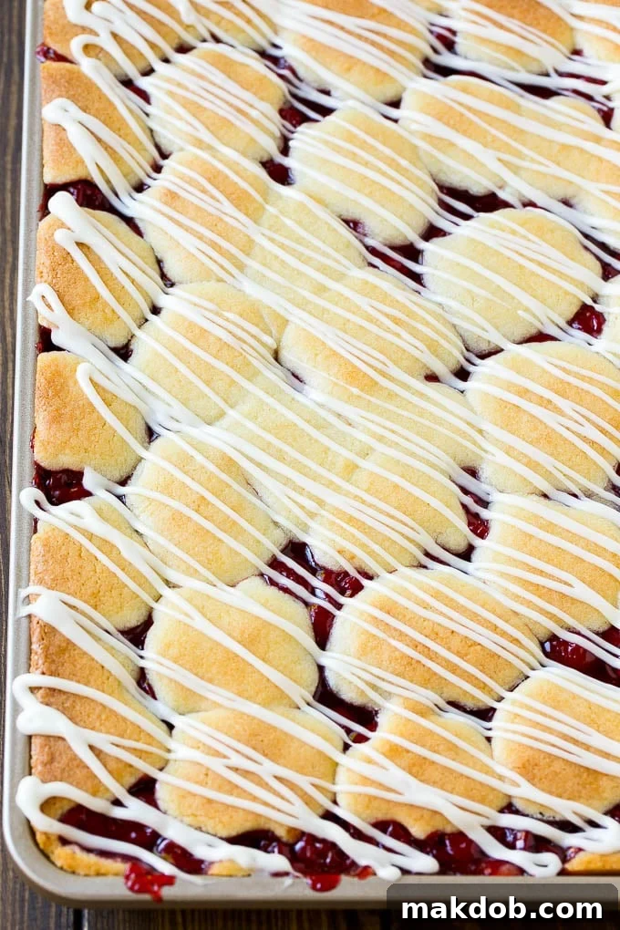 Cherry Bars Recipe | Cherry Pie Bars | Cherry Cookies | Bar Cookies #cookies #bars #cherry #baking #dessert #sweets #dinneratthezoo Cherry bars topped with vanilla glaze.