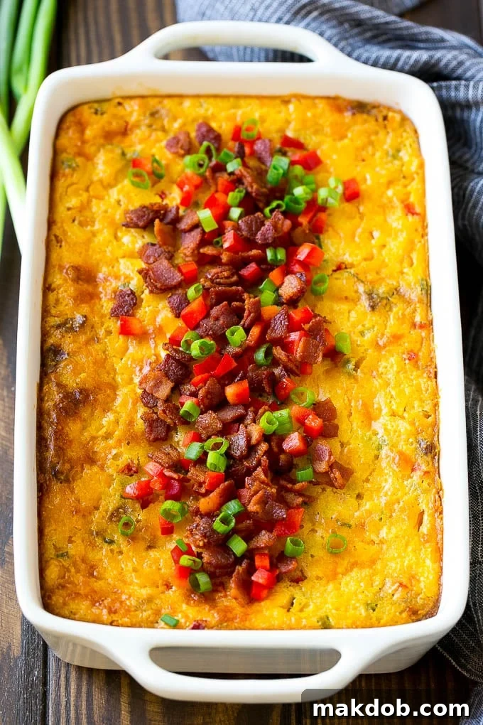 Loaded Corn Casserole Recipe | Easy Corn Casserole | Bacon Corn Casserole | Corn Pudding #corn #casserole #bacon #cheese #sidedish #thanksgiving #dinner #dinneratthezoo A beautifully baked casserole of loaded corn, topped with crispy bacon, bright red peppers, and fresh green onions, ready to serve.