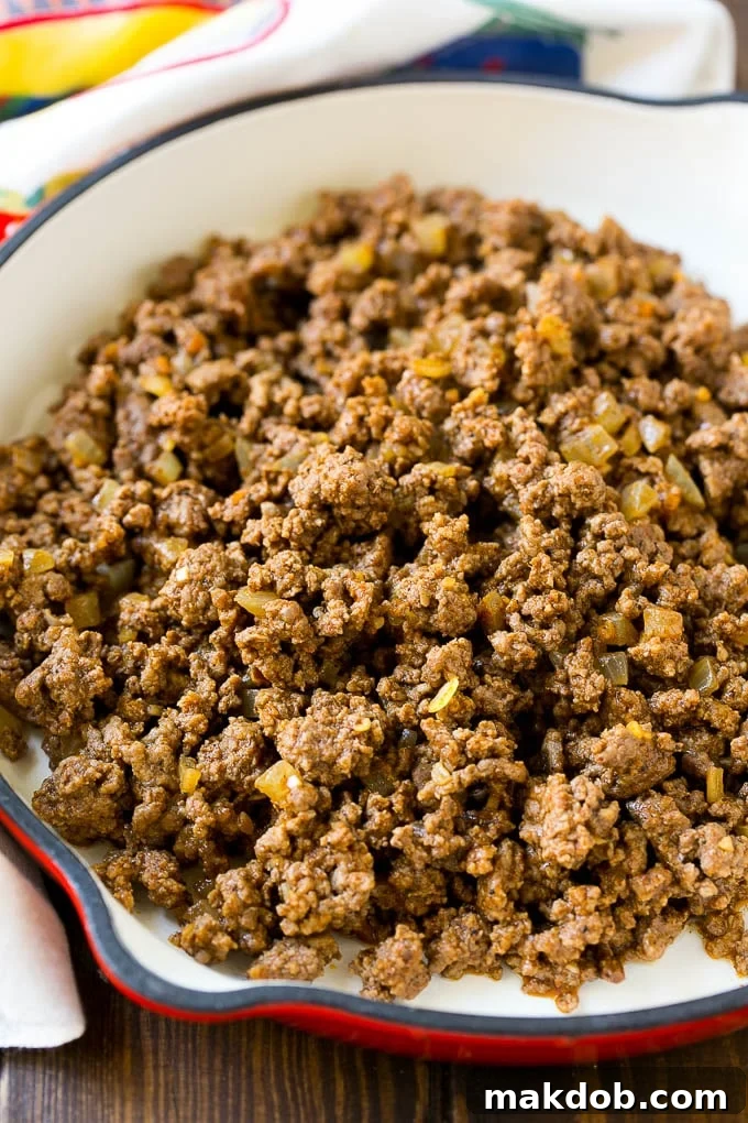 Mexican Stuffed Shells Recipe | Stuffed Shells | Mexican Pasta #dinner #pasta #mexican #beef #noodles #cheese #dinneratthezoo A pan of taco seasoned ground beef and onions.