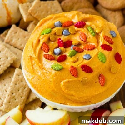 Pumpkin dip served with apples, gingersnap cookies and graham crackers.