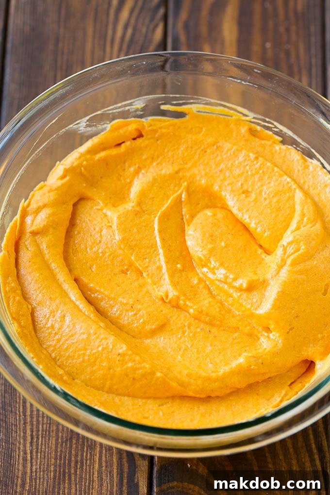 A bowl of fluffy pumpkin dip, ready to be enjoyed with various dippers.