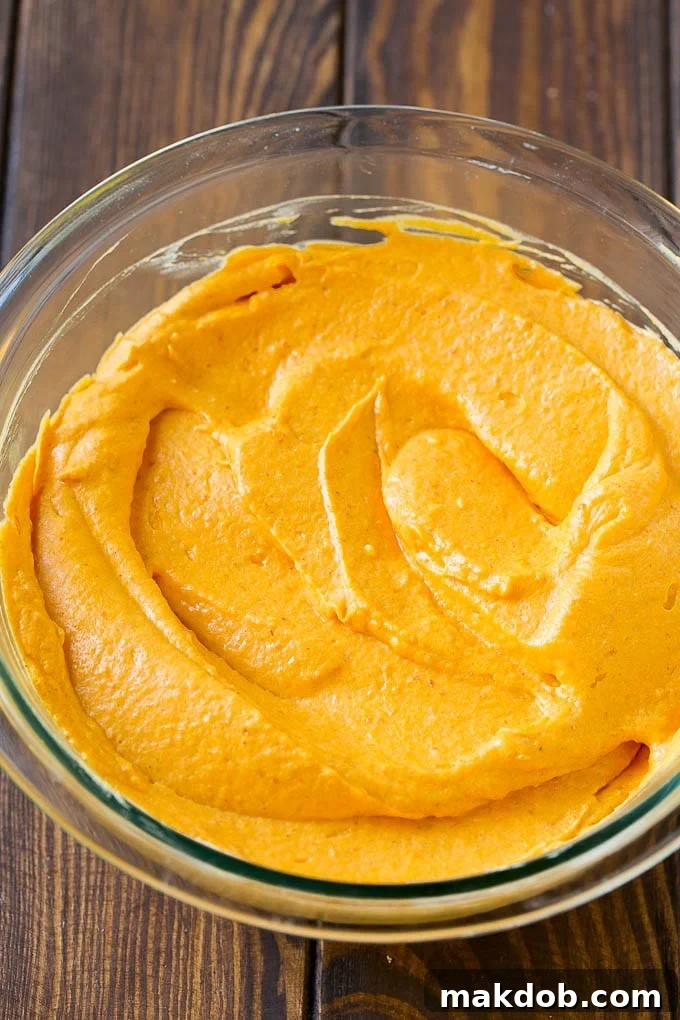 Delicious Fluffy Pumpkin Dip A beautifully presented bowl of fluffy pumpkin dip, ready to be enjoyed as a delightful fall dessert or appetizer.
