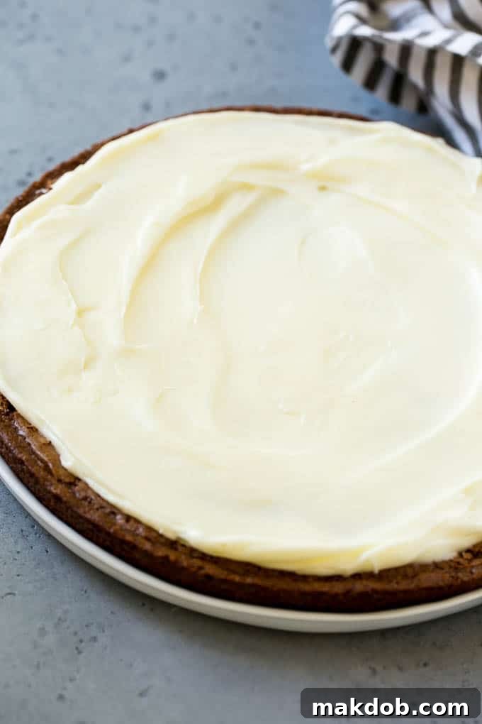 A large round brownie with cream cheese frosting.