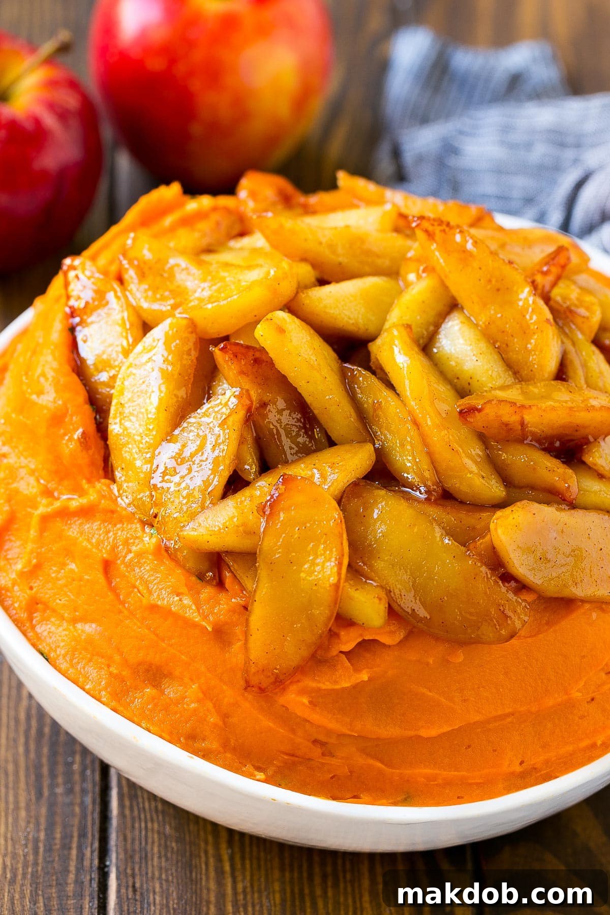 Mashed sweet potatoes generously topped with cooked, caramelized apples.