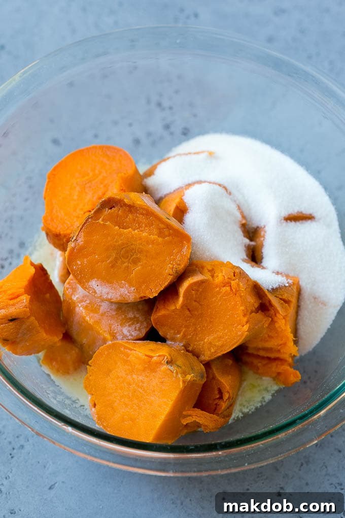 Ruth's Chris Sweet Potato Casserole Recipe | Sweet Potato Casserole | Mashed Sweet Potatoes #sweetpotatoes #casserole #thanksgiving #christmas #holidays #dinner #dinneratthezoo #sidedish Sweet potatoes, sugar and butter in a bowl.