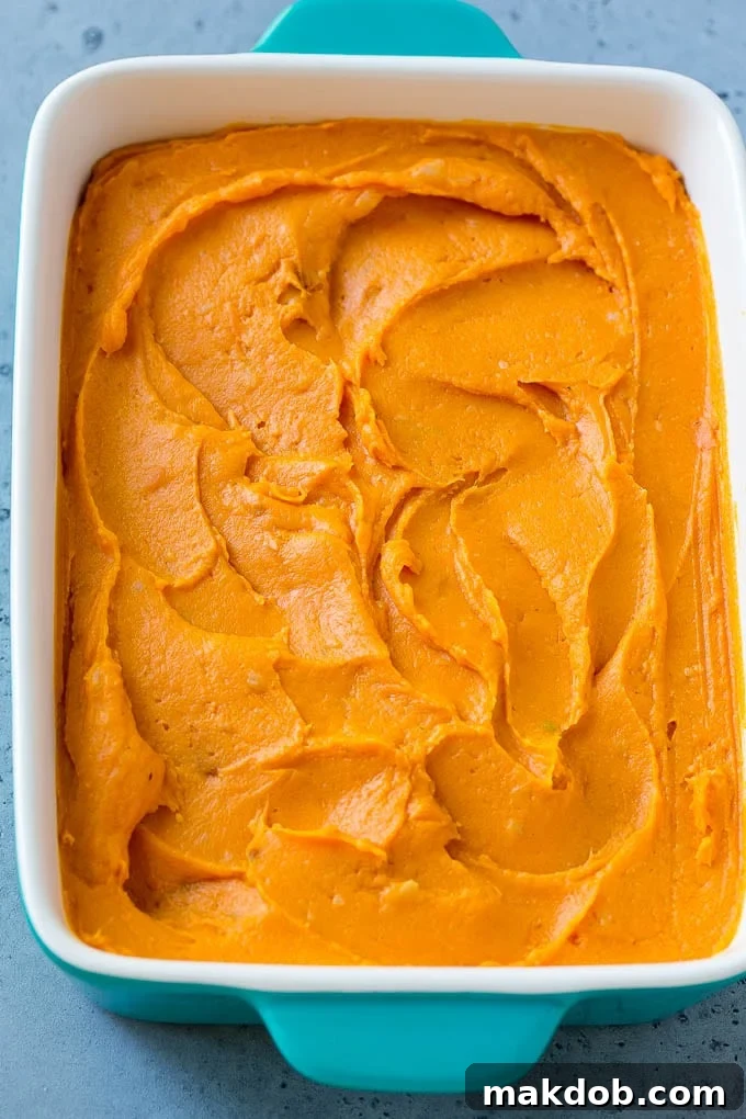 Ruth's Chris Sweet Potato Casserole Recipe | Sweet Potato Casserole | Mashed Sweet Potatoes #sweetpotatoes #casserole #thanksgiving #christmas #holidays #dinner #dinneratthezoo #sidedish A pan of mashed sweet potatoes.