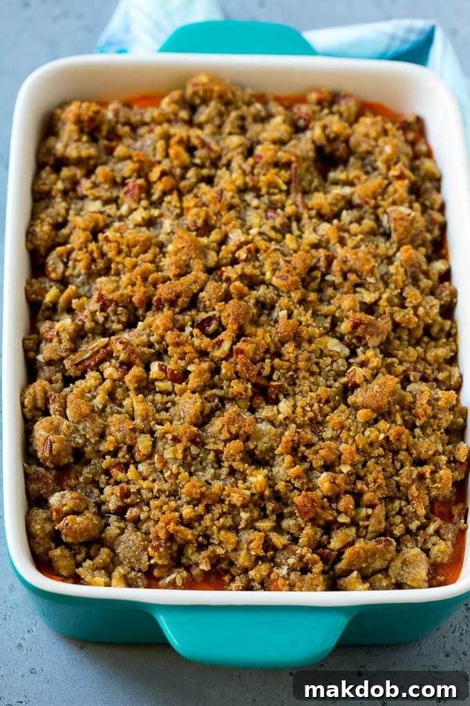 Ruth's Chris Sweet Potato Casserole Recipe | Sweet Potato Casserole | Mashed Sweet Potatoes #sweetpotatoes #casserole #thanksgiving #christmas #holidays #dinner #dinneratthezoo A baking dish of Ruth's Chris sweet potato casserole topped with streusel.