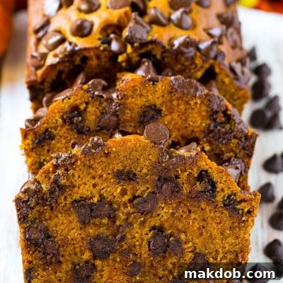Sliced pumpkin chocolate chip bread on a serving board.
