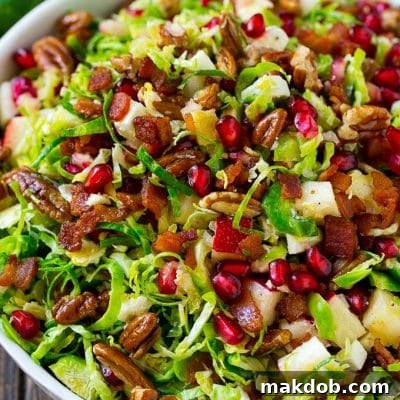Brussels sprout salad with shredded brussels sprouts, pomegranate, pecans, feta cheese, apples and bacon.
