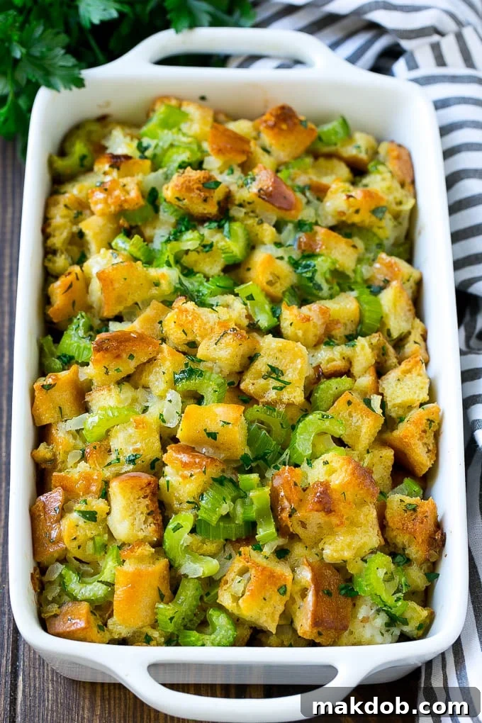Classic Turkey Stuffing Recipe for Thanksgiving | Easy Homemade Side Dish Baked turkey stuffing in a dish topped with fresh parsley, ready to be served at Thanksgiving.