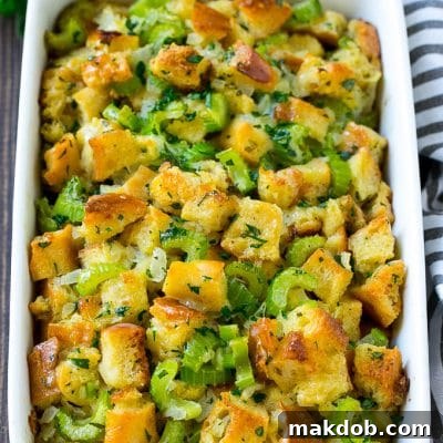 Baked turkey stuffing in a dish topped with fresh parsley.